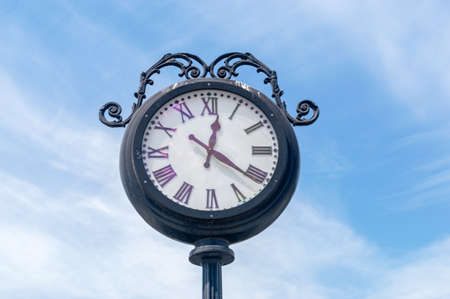 Large exterior clock on clue sky. Street vintage retro clock.の写真素材