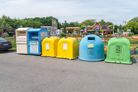 Pruszkow, Poland - June 15, 2021: Containers of collection of clothes for charity and colorful containers for separate garbage collection.のeditorial素材
