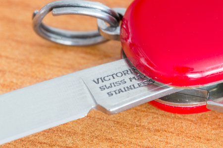Pruszcz Gdanski, Poland - July 17, 2021: Detail of sign Victorinox Swiss made stainless on red Swiss Army knife Victorinox.のeditorial素材