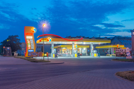 Malbork, Poland - July 26, 2021: Lotos gas station at night.のeditorial素材