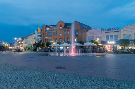 Malbork, Poland - July 26, 2021: Water fountain on Kazimierz Jagiellonczyk (Casimir IV Jagiellon) Square at night.のeditorial素材