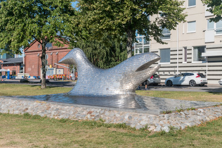 Turku, Finland - August 6, 2021: Symbiosis is a sculpture by Finnish artist Stefan Lindfor. Sculpture of fish on the embankment of the river Aura.のeditorial素材