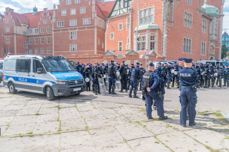 Gdansk, Poland - August 21, 2021: Police officers and car at the Tricity Pride March. Manifestants demands for better rights and equality.のeditorial素材