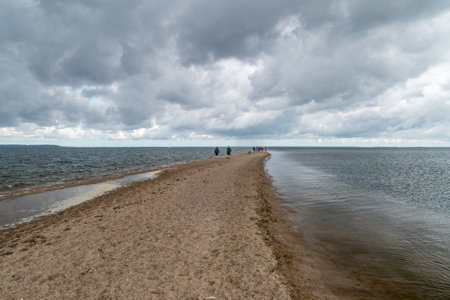 Rewa, Poland - August 21, 2021: View on sandy Rewa peninsula with people in the end at cloudy day.のeditorial素材