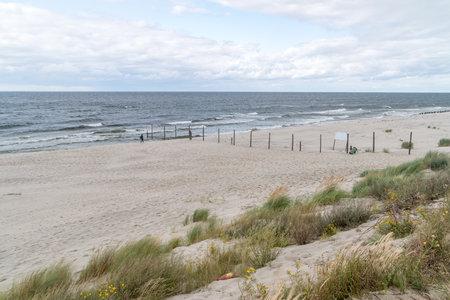 Piaski, Poland - August 17, 2021: Beach with fence of Polish - Russian border on Balic seashore.のeditorial素材