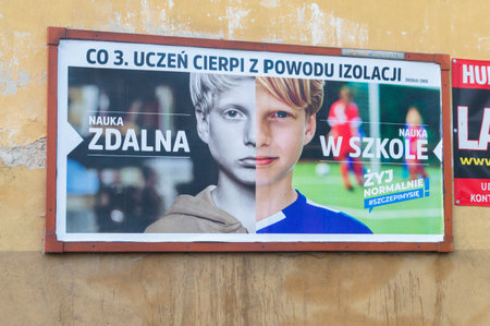 Chojnice, Poland - September 22, 2021: Billboard encouraging vaccination against COVID-19. Poster informing about the suffering of students due to isolation.のeditorial素材