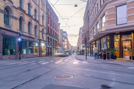 Oslo, Norway - September 24, 2021: Street view with tram track in city center with beautiful sunrise in Oslo.のeditorial素材