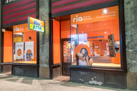 Oslo, Norway - September 24, 2021: Ria Money Transfer office at night.のeditorial素材