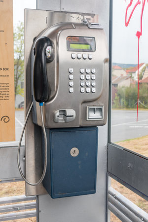 Oslo, Norway - September 24, 2021: Phone in telephone box.のeditorial素材
