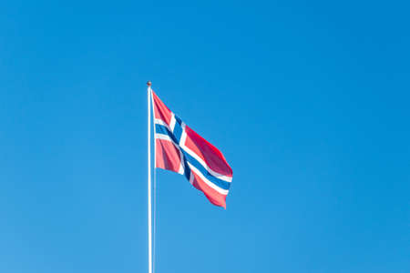 National flag of Kingdom of Norway on blue sky.