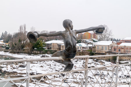 Kutaisi, Georgia - March 17, 2022: Bronze sculpture of boy with hats on White Bridge over Rioni river.のeditorial素材