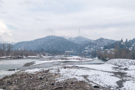 Panoramic view on caucasian river Rioni in winter.