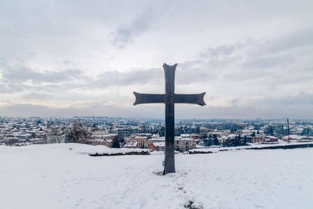 Cross on Bagrati hillside with view on Kutaisi city.の写真素材