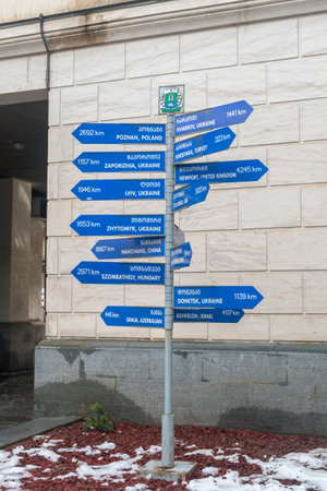 Kutaisi, Georgia - March 19, 2022: Arrows pointing direction and distances measured from the Kutaisi to the different cities in the World.のeditorial素材