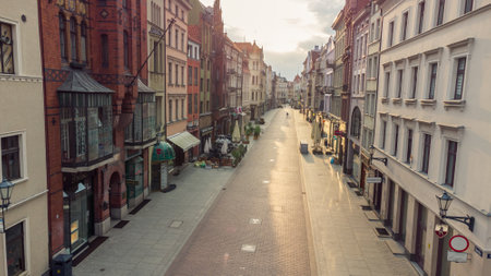 Torun, Poland - July 26, 2021: Sunrise on street with coats of arms of many cities.