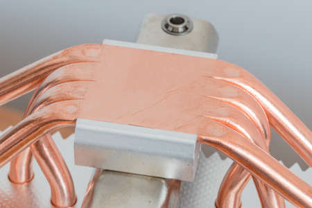 Copper heat sink of cpu cooling radiator. Detail of bottom of silver aluminum CPU radiator with...