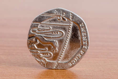 UK twenty pence coin on wooden table.の写真素材