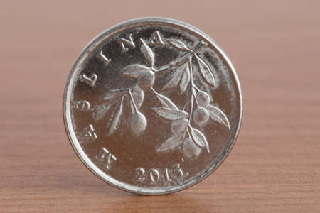 Croatian coin Jul 20 on wooden table.