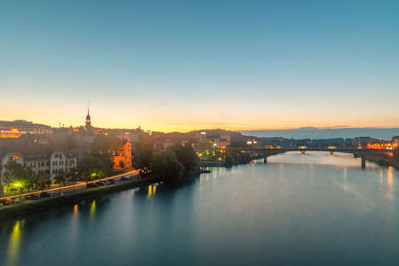 Maribor, Slovenia - June 2, 2022: Sunrise view on Drava (Drave) river with bridge and Maribor city.のeditorial素材