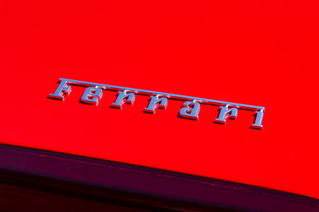 Bydgoszcz, Poland - July 9, 2023: Logo and sign of Ferrari on red Ferrari car.のeditorial素材