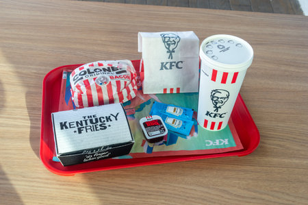 Cubzac-les-Ponts, France - September 5, 2023: KFC Colonel bacon original burger, the Kentucky fries, 2 Tenders XL and Pepsi for drink.のeditorial素材