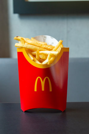 Antwerp, Belgium - February 24, 2024: McDonald french fries in red box.のeditorial素材