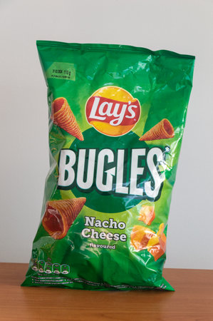 Pruszcz Gdanski, Poland - March 3, 2024: Pack of Lays bugles nacho cheese flavored.のeditorial素材