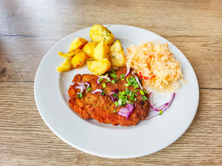 Pork chop with baked potatoes and sauerkraut.の写真素材