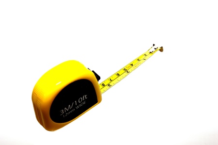 The yellow measure tape on the white background.の写真素材