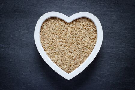 Heart filled with brown riceの写真素材