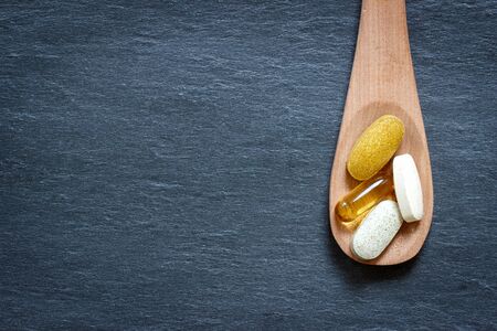 Healthy supplement on wooden spoon