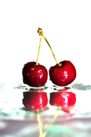two cherries on watered glassの写真素材