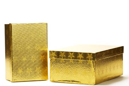 two closed golden present boxes with stars on white backgroundの写真素材