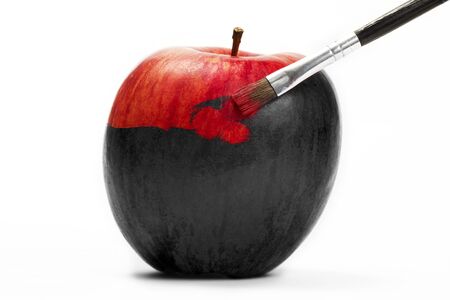 a red apple gets his color with a brush on white backgroundの写真素材