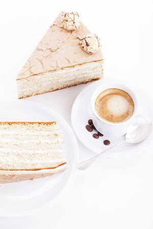 hazelnut cream cake from top with a cup of coffee on white backgroundの写真素材