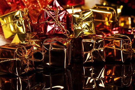 many small colorful christmas presents on blackの写真素材