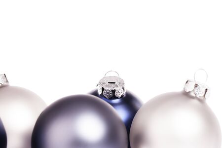 closeup of some blue and silver christmas balls on white backgroundの写真素材