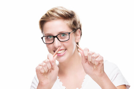 blonde woman wearing glasses has broken her pencil on white backgroundの写真素材