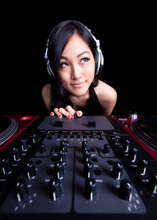 Wide angle shot of a female DJ using the fader.の写真素材