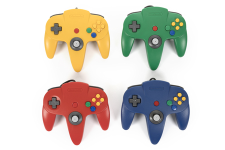 Taipei, Taiwan - February 18, 2018: A studio shot of a four Nintendo 64 controllers on a white...