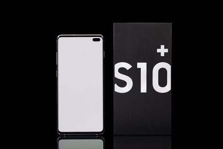 Taipei, Taiwan - March 7, 2019: A studio shot of the new Samsung Galaxy S10+ cellphone and box on a reflective black surfaceのeditorial素材