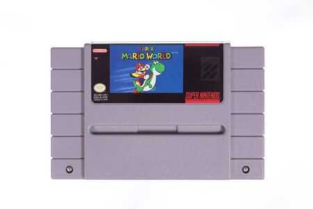 Taipei, Taiwan - May 31, 2019: A floating Super Mario World cartridge for the SNES isolated on a...