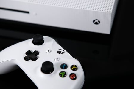 Taipei, Taiwan - June 20, 2019: A close-up shot of a white Microsoft XBOX One S system and controller on a black surfaceのeditorial素材