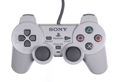 Taipei, Taiwan - May 31, 2019: A floating gray Sony Playstation controller isolated on a white...