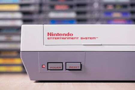 Taipei, Taiwan - March 17, 2019: A studio shot of a Nintendo Entertainment System and games on a wooden tableのeditorial素材