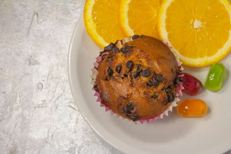 Tasty looking colorful dessert with oranges, muffins and sweets. Top view close up. High quality photoの写真素材