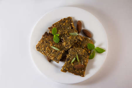 Whole grain homemade crispbread in the white plate on white background. Healthy lifestyle breakfast. High quality photoの写真素材