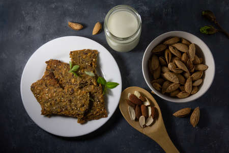 Whole grain homemade crispbread with milck and almonds. Healthy lifestyle breakfast. High quality photoの写真素材