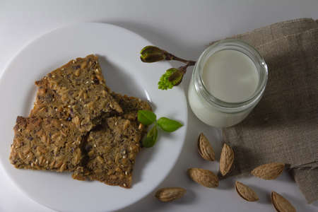 Whole grain homemade crispbread with milck and almonds. Healthy lifestyle breakfast. High quality photoの写真素材
