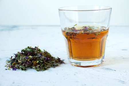 Natural herbal homemade meadow tea in a glass on white background. High quality photoの写真素材